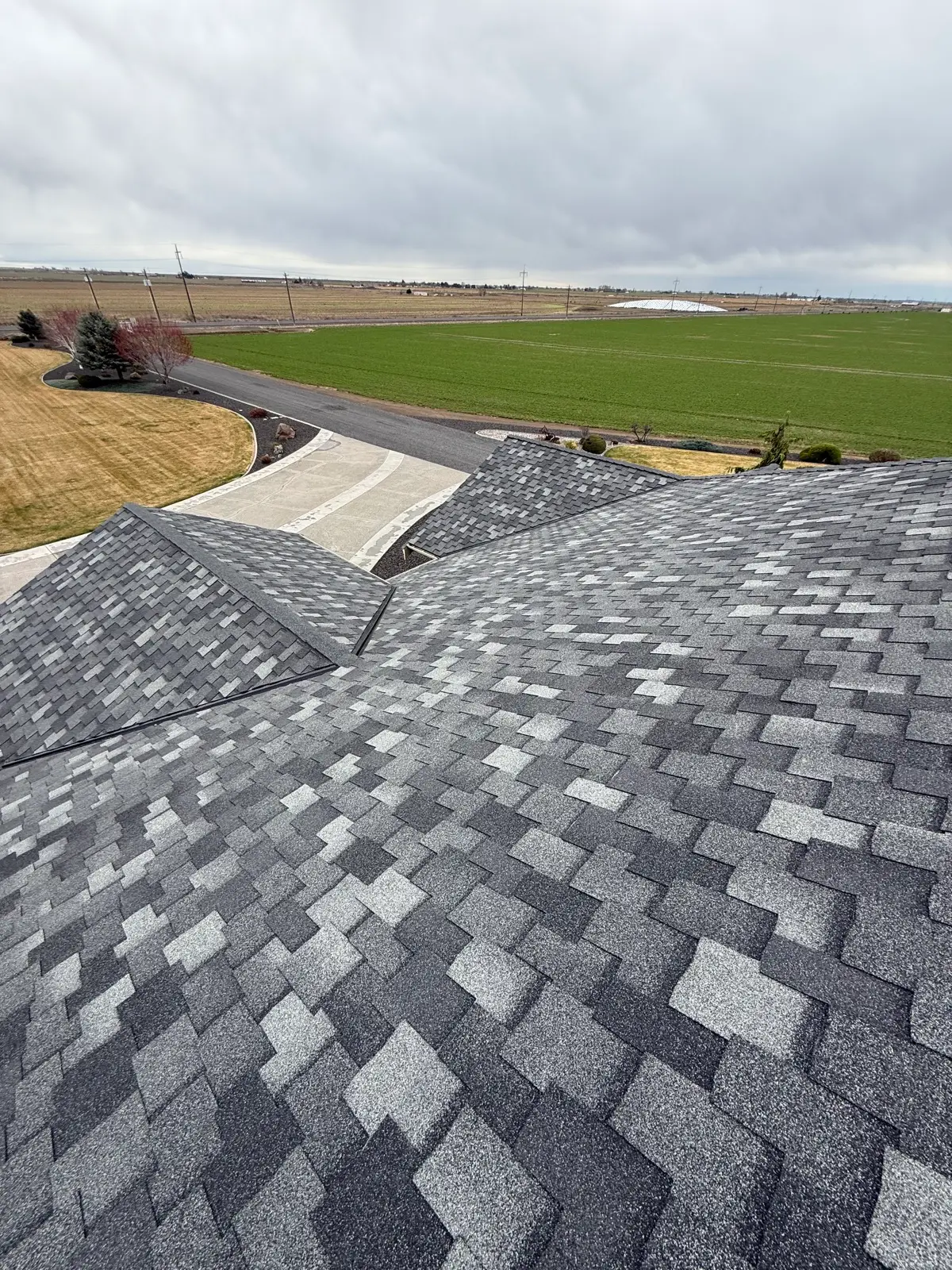 Completed grey designer asphalt shingle roof seen from above